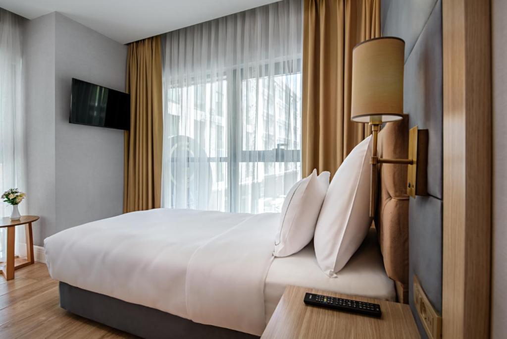 Postel nebo postele na pokoji v ubytování Gleam Bomonti Hotel