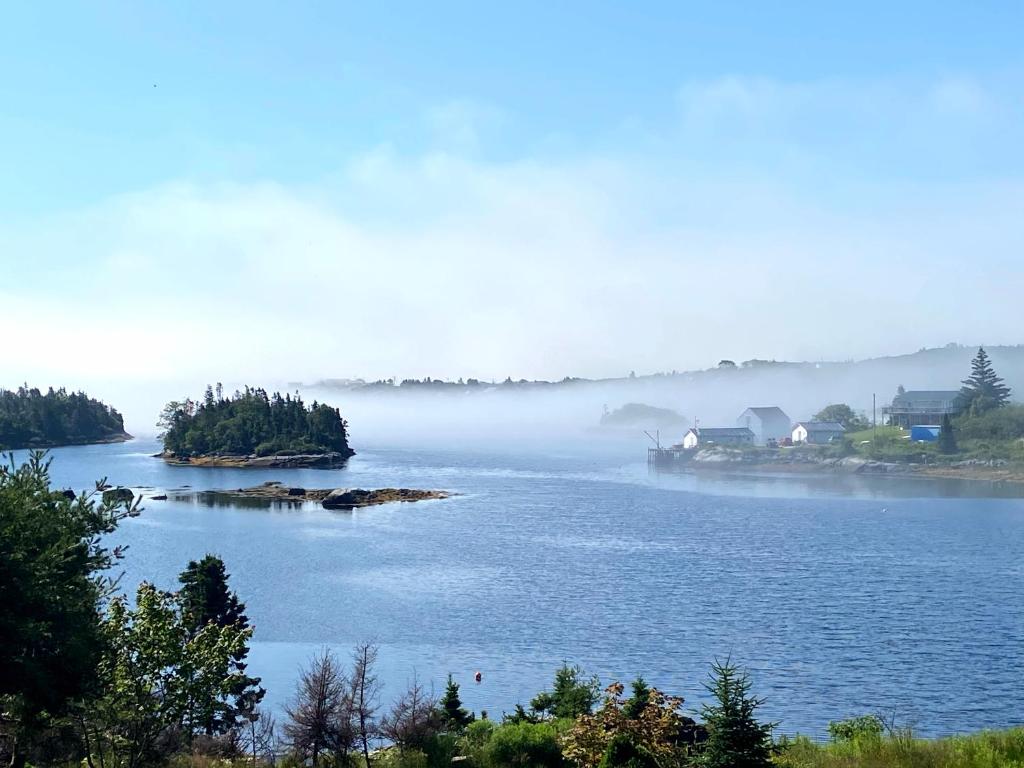 a view of a lake with fog on the water at 181 Oceanside Inn in Peggy's Cove