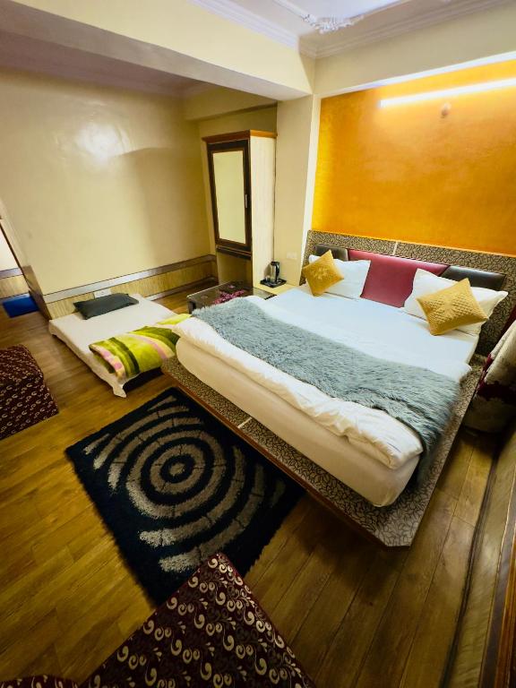 Postel nebo postele na pokoji v ubytování Hotel Apple Regency