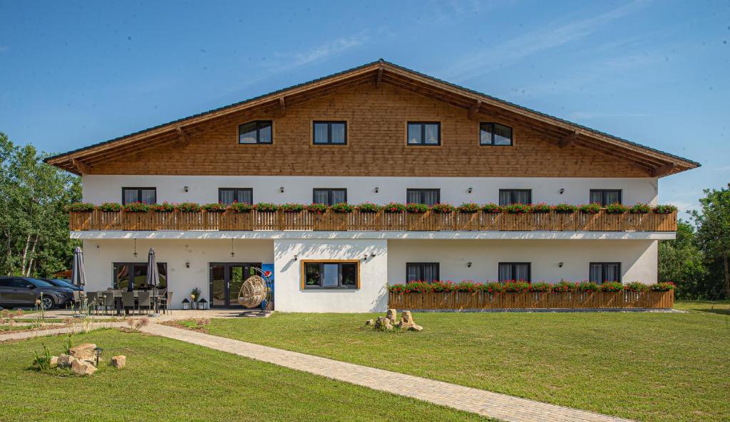 a large white house with animals in front of it at Casa Hirsch in Avrig