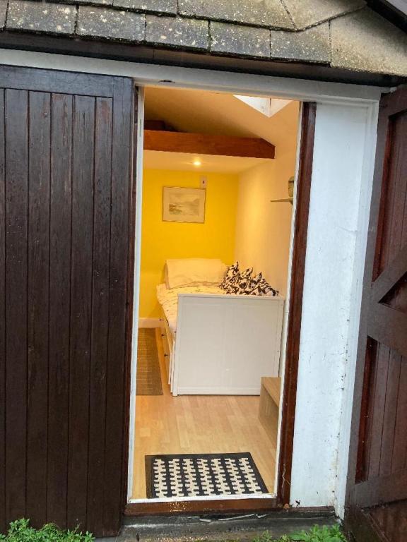 a view of a bedroom with a bed in a room at Studio Annexe with separate shower room in Broadhempston