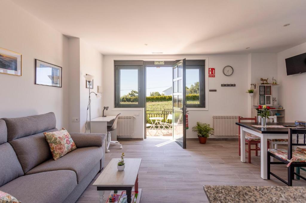 a living room with a couch and a table at Apartamentos A Chousa in Valdoviño