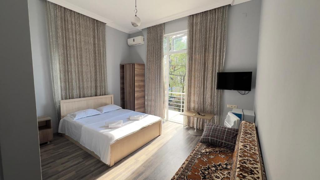 Postel nebo postele na pokoji v ubytování Grand Hotel Kobuleti