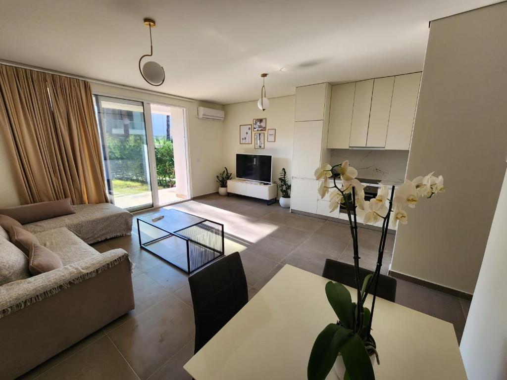 a living room with a couch and a table at SanPietro Relax Apartment in Durrës