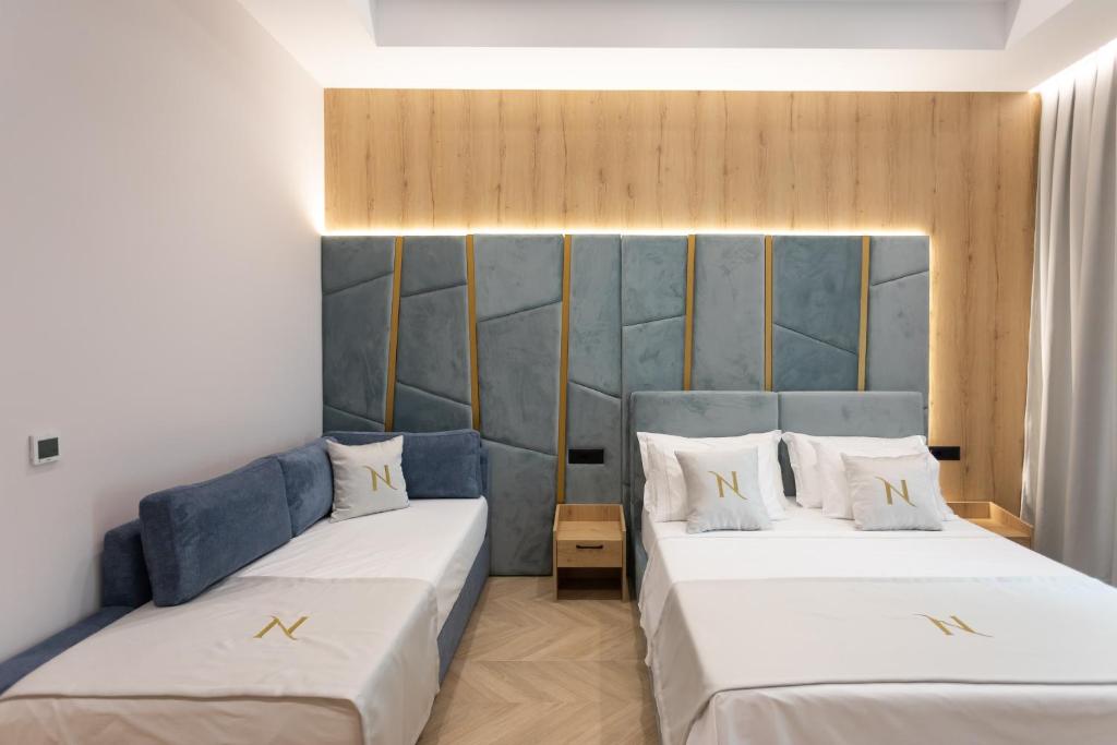 Postel nebo postele na pokoji v ubytování Nayel Hotel