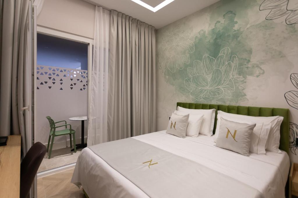 Postel nebo postele na pokoji v ubytování Nayel Hotel