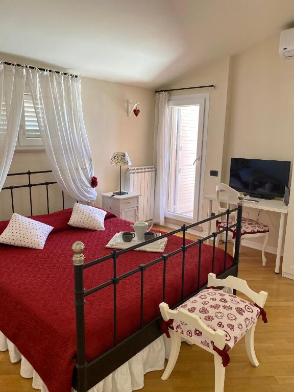 a bedroom with a bed with a red bedspread at Villa Serena in Monopoli