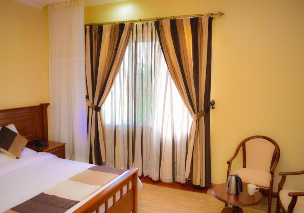 Postel nebo postele na pokoji v ubytování Red Ruby Hotel