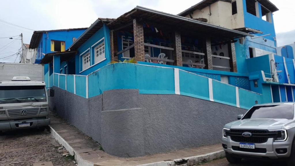 a truck parked in front of a blue building at Blue House in Lençóis