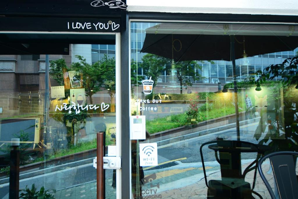 a store window with an umbrella in front of a street at Residence Unicorn in Seoul