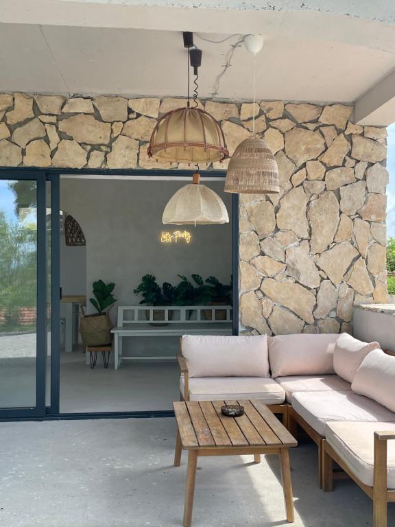 a living room with a couch and a stone wall at House Joie in Blaguša