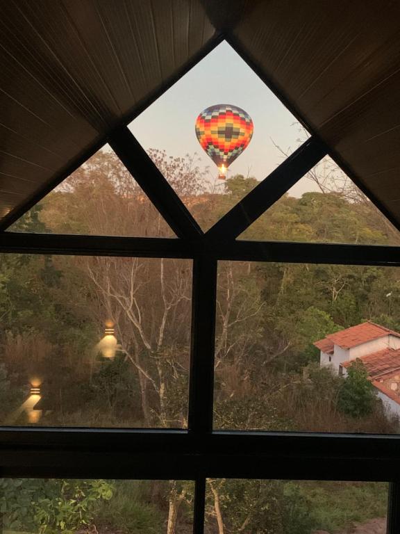 a view of a hot air balloon from a window at Chalés Piribless-Ikigai in Pirenópolis