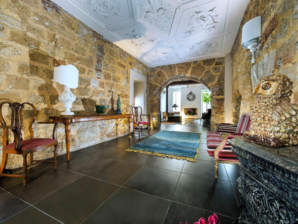 a living room with a stone wall at Il Giardino di Ballarò Boutique B&B in Palermo