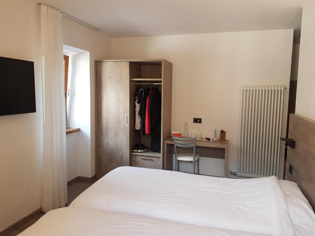 Postel nebo postele na pokoji v ubytování Hotel Zanella