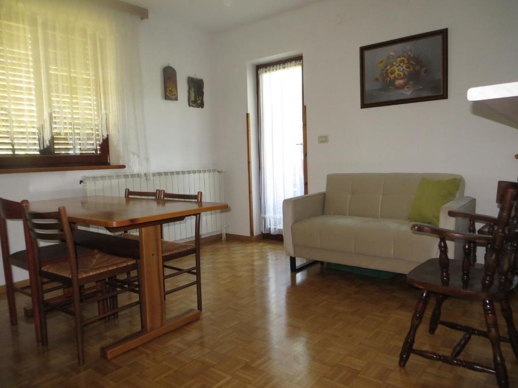 a living room with a couch and a table at Sobe Orešje in Črniče