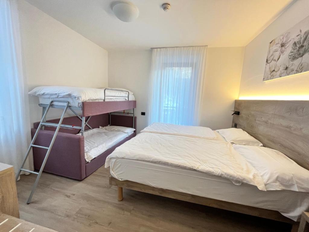 Postel nebo postele na pokoji v ubytování Hotel Zanella