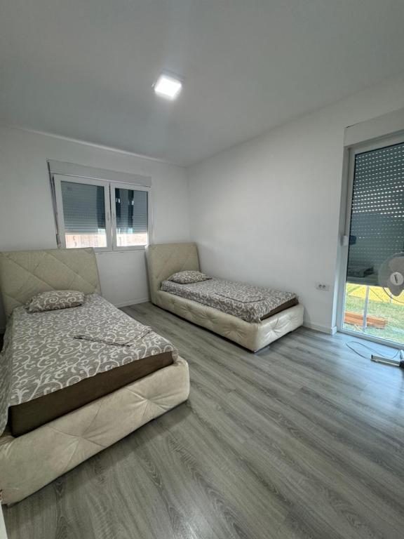 Postel nebo postele na pokoji v ubytování Apartmani ZMS