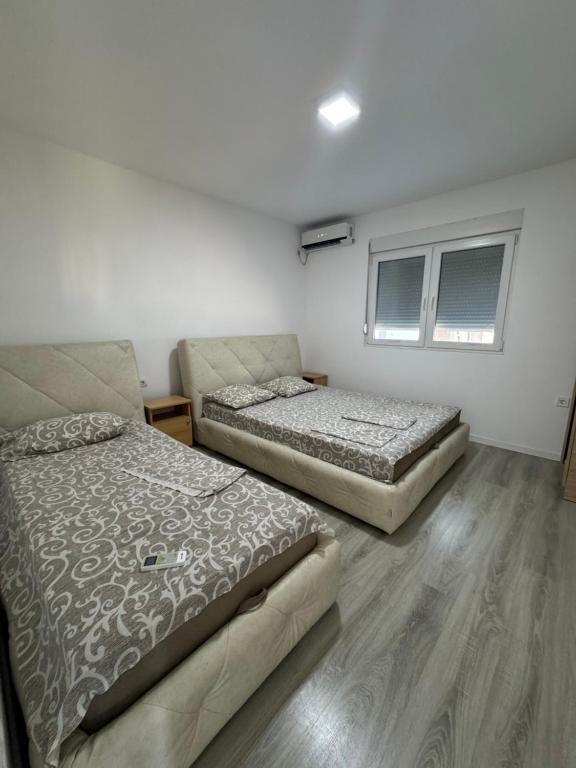 Postel nebo postele na pokoji v ubytování Apartmani ZMS