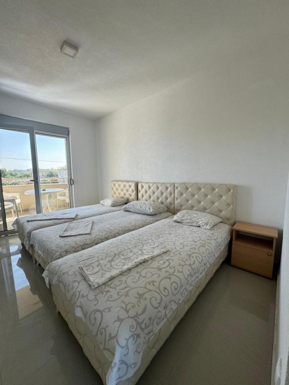 Postel nebo postele na pokoji v ubytování Apartmani ZMS