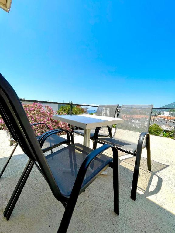 a table and chairs sitting on a patio at KAP Apartments in Sutomore