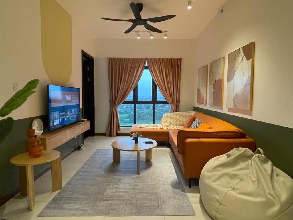 a living room with a couch and a ceiling fan at K Avenue Kota Kinabalu in Donggongon