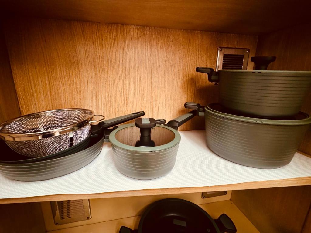 a shelf with pots and pans on it at La casa di Grace in Florence