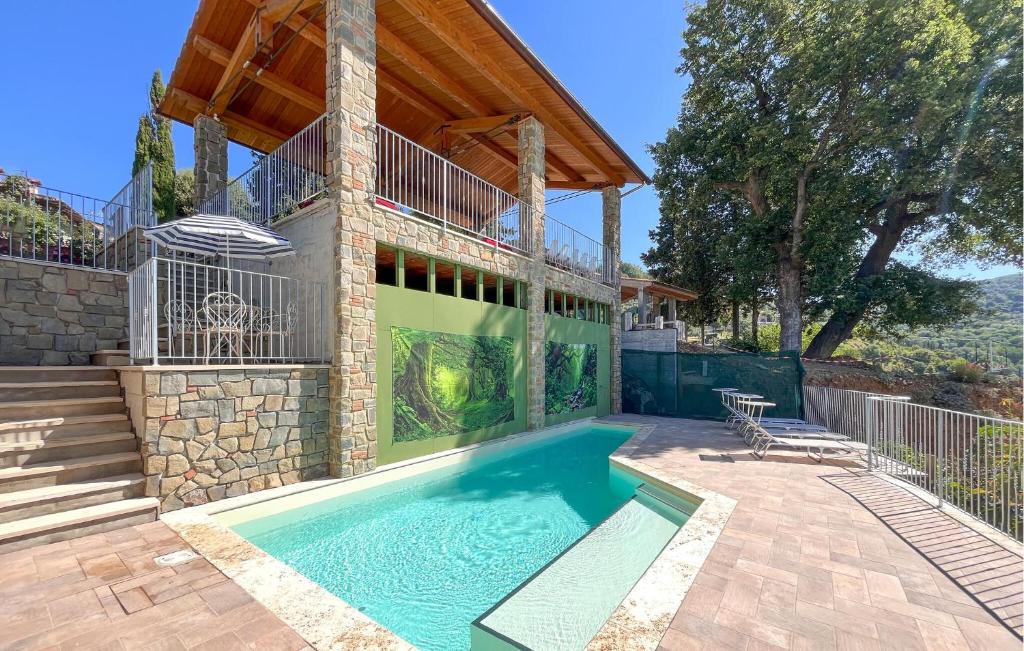 a swimming pool in front of a house with a wooden roof at Stunning Home In Arezzo With Kitchen in Arezzo