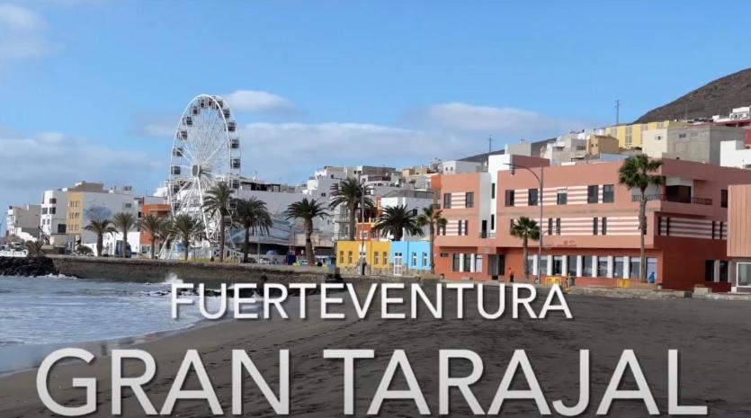a view of a city with a ferris wheel in the background at El Rinconcito de Ensueño in Gran Tarajal