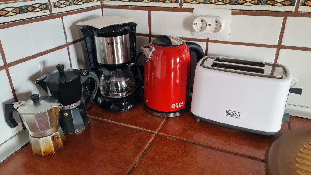 a kitchen counter with a toaster and other appliances at Los Cerrajones: spectacular views from the cliff in Agulo