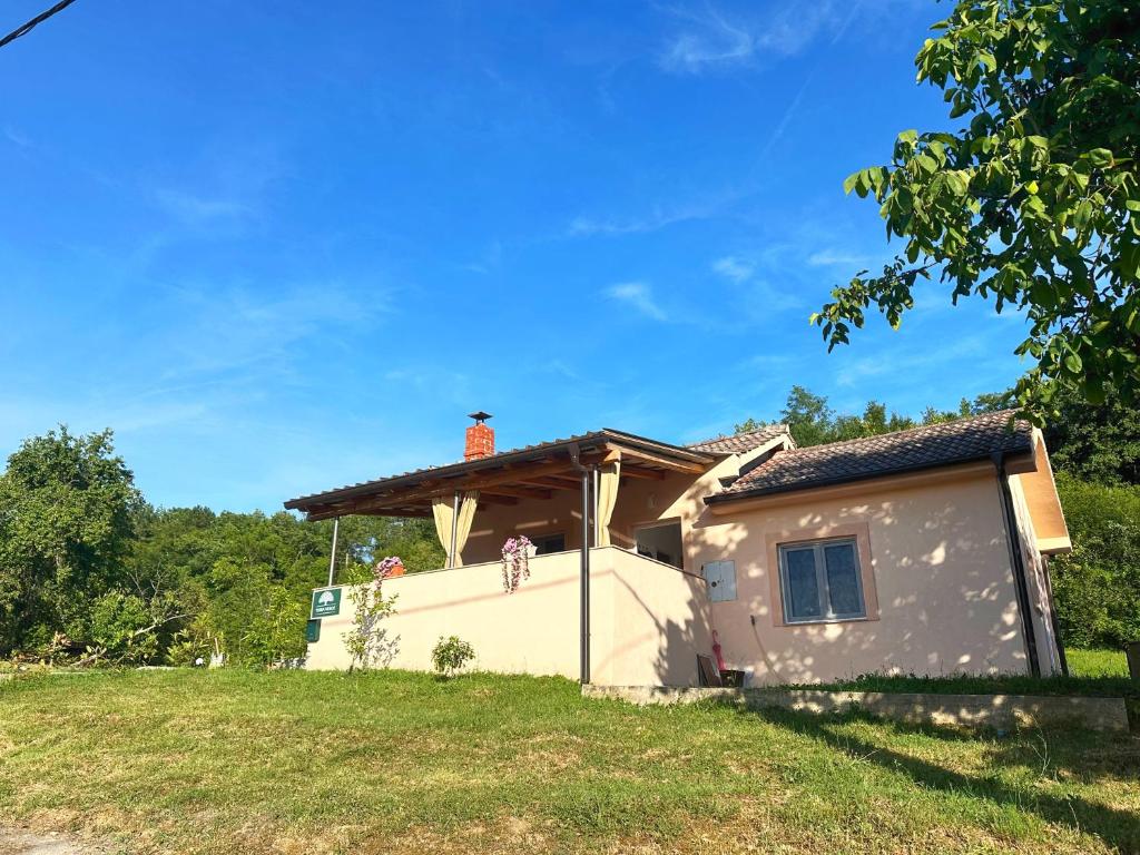 a small house with a roof on a grass field at Terra Verde in Račički Brijeg