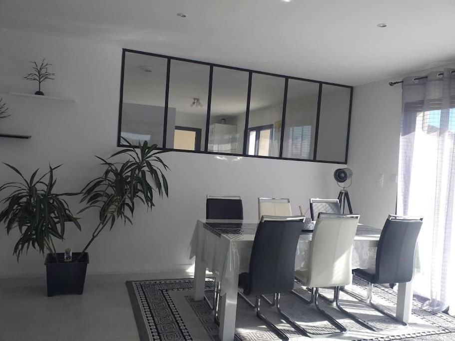 un bureau avec une table, des chaises et un miroir dans l'établissement maison 3 chambres avec terrasse couverte, à Mazières-en-Mauges
