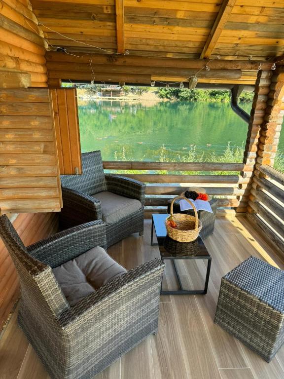 a living room with two chairs and a table at Dolce vita cottage - waterfront in Bihać