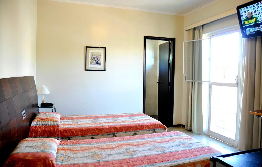 Postel nebo postele na pokoji v ubytování Hotel Cidade