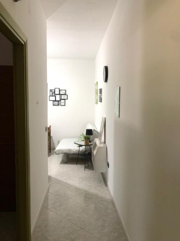 a white hallway with a table and a couch at Casa Turusele in Santa Maria Navarrese