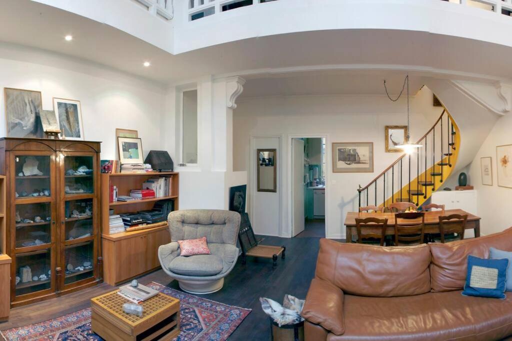 - un salon avec un canapé, une chaise et une table dans l'établissement The Eifel Tower Artist Loft, à Paris