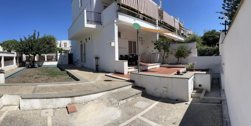 an empty courtyard of a white apartment building at A due passi dal mare in Santa Marinella