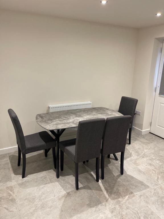 a table and chairs in a dining room at Mesnes Place in Wigan