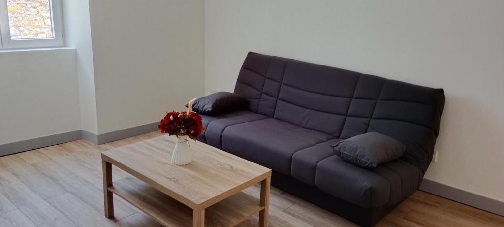 a living room with a couch and a coffee table at Maison de village rénovée in Lédignan