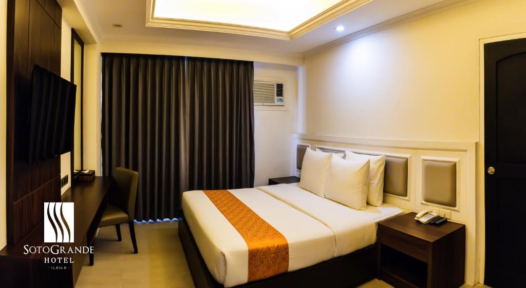Postel nebo postele na pokoji v ubytování Sotogrande Iloilo Hotel