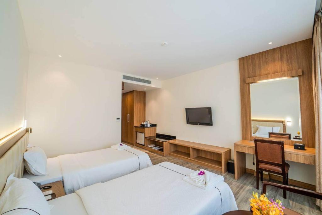 Postel nebo postele na pokoji v ubytování Le President Hotel