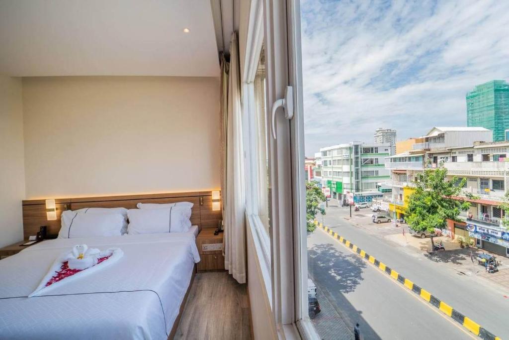 Postel nebo postele na pokoji v ubytování Le President Hotel