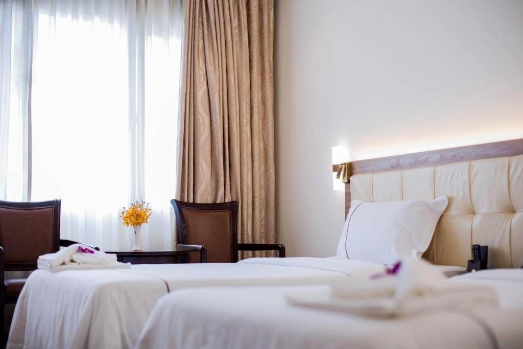Postel nebo postele na pokoji v ubytování Le President Hotel