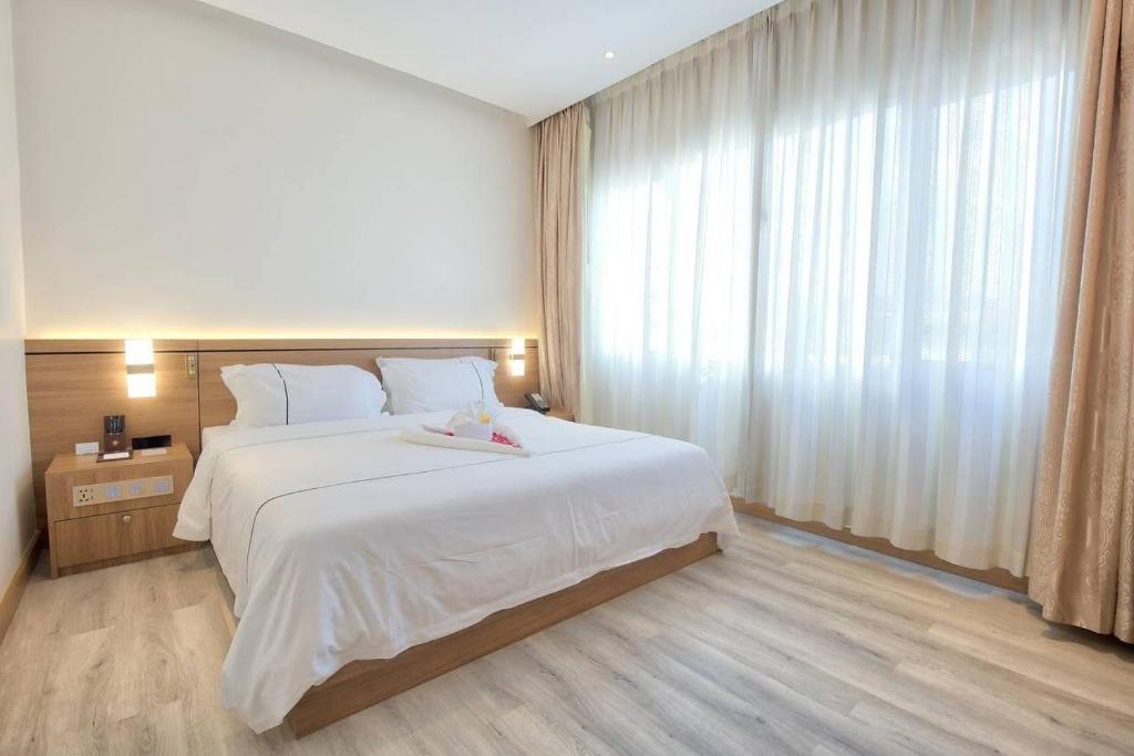 Postel nebo postele na pokoji v ubytování Le President Hotel