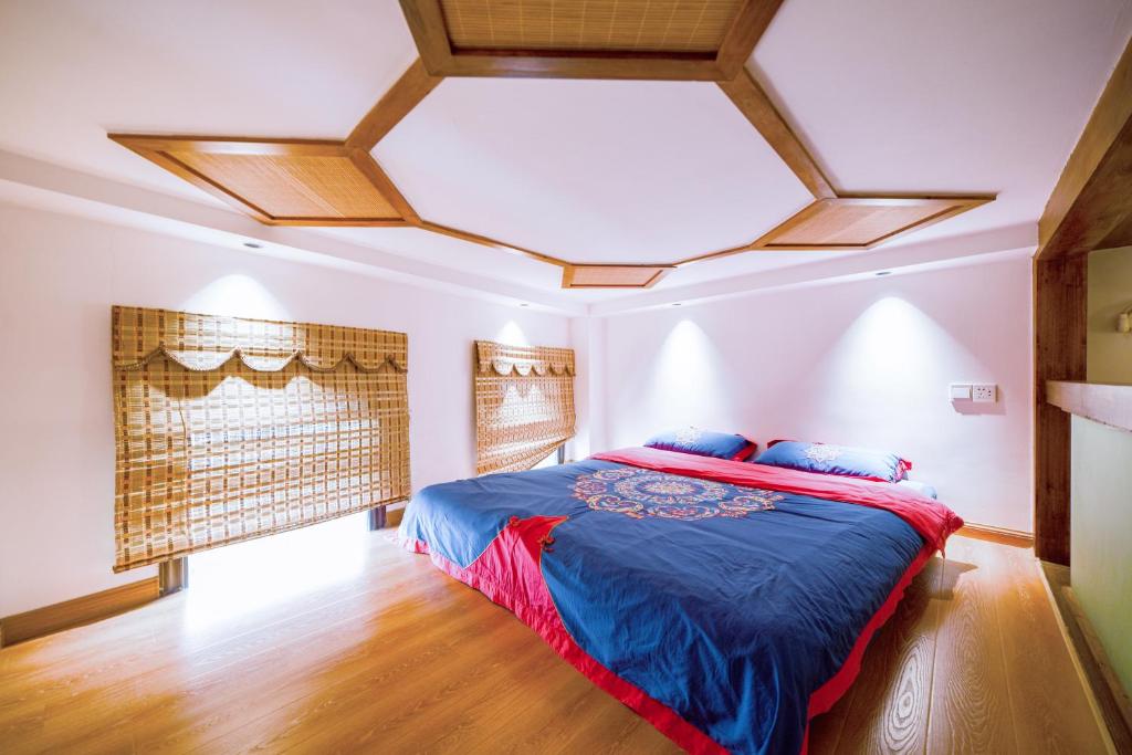 En eller flere senge i et værelse på Zhangjiajie Han Exotic Inn