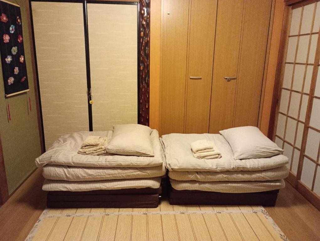 Postel nebo postele na pokoji v ubytování Sakurah