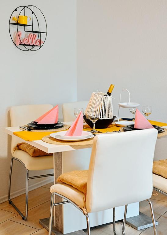 a dining room table with plates and napkins on it at Family studio apartman in Karlovac