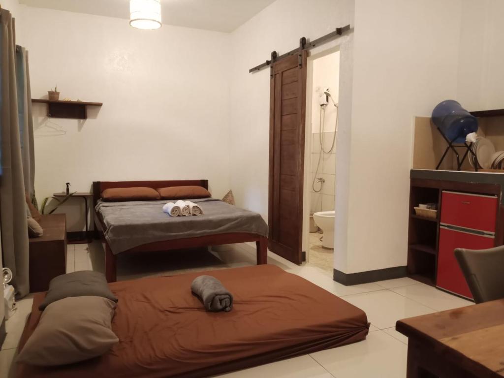Postel nebo postele na pokoji v ubytování Pascoe's Units Siargao- Suites