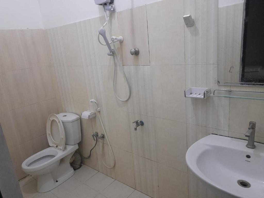 a bathroom with a shower and a toilet and a sink at Blue Ocean Hotel in Trincomalee