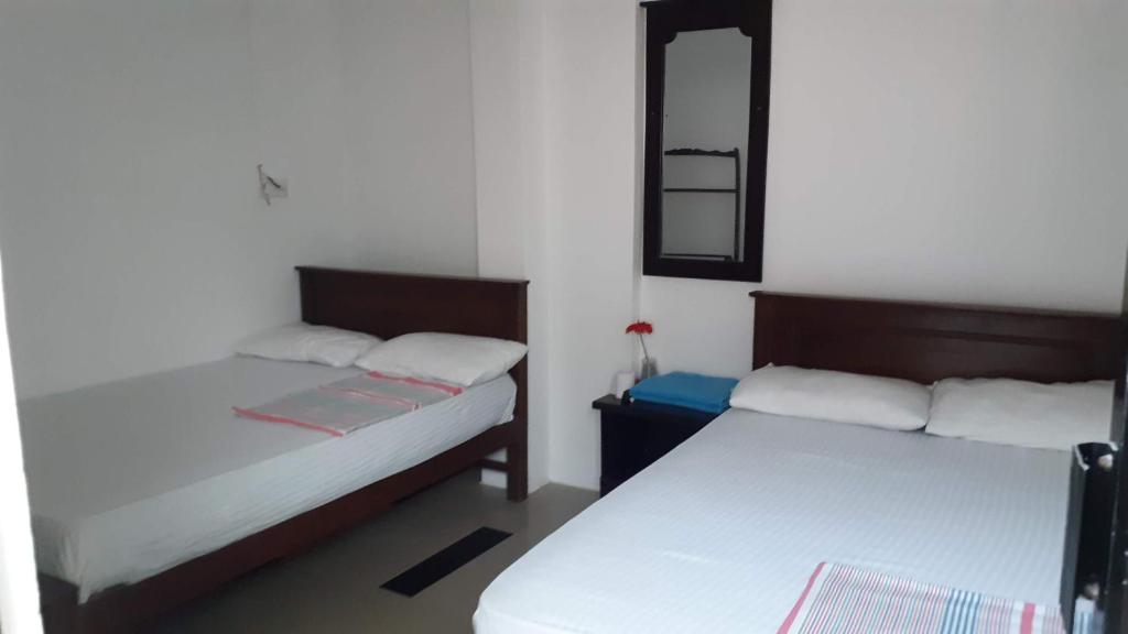 Postel nebo postele na pokoji v ubytování Blue Ocean Hotel