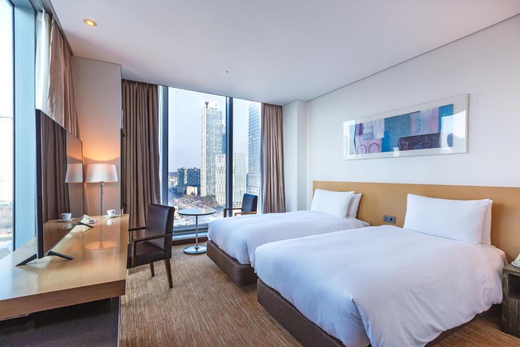 Postel nebo postele na pokoji v ubytování Orakai Songdo Park Hotel